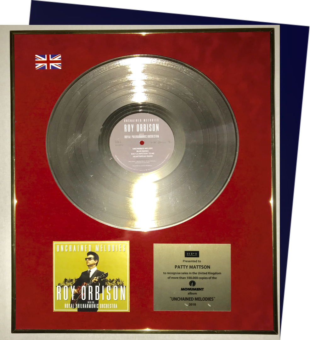 A gold record with a picture of a man on it.