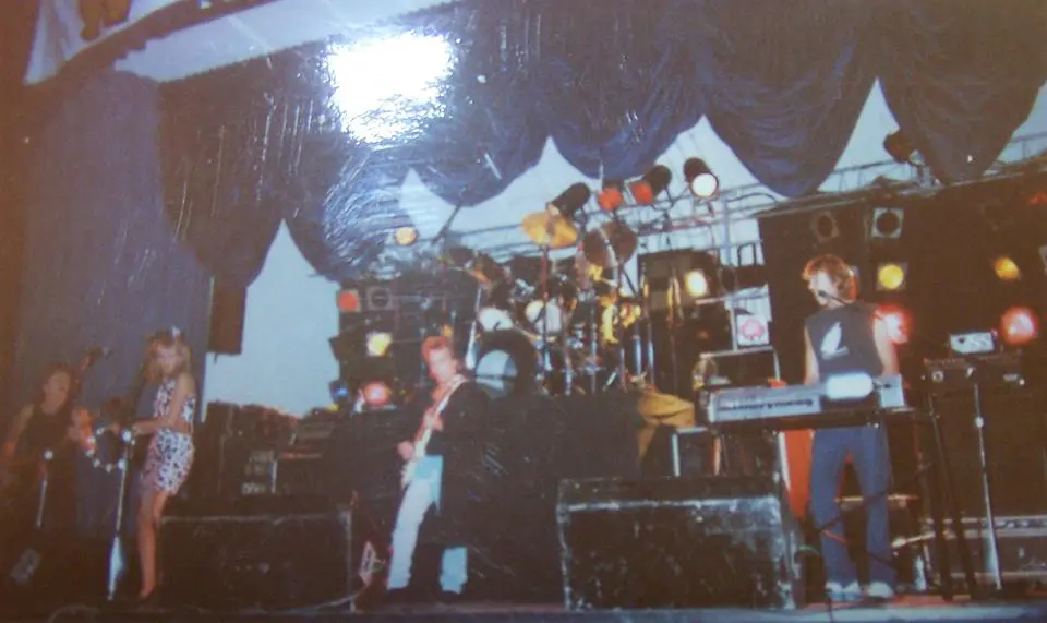 A man standing in front of a stage with many instruments.